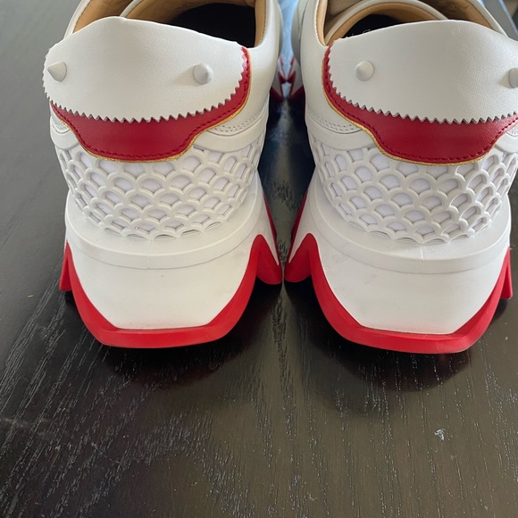 Brand new in a box. All White calfskin leather red signature on heel.gold logo